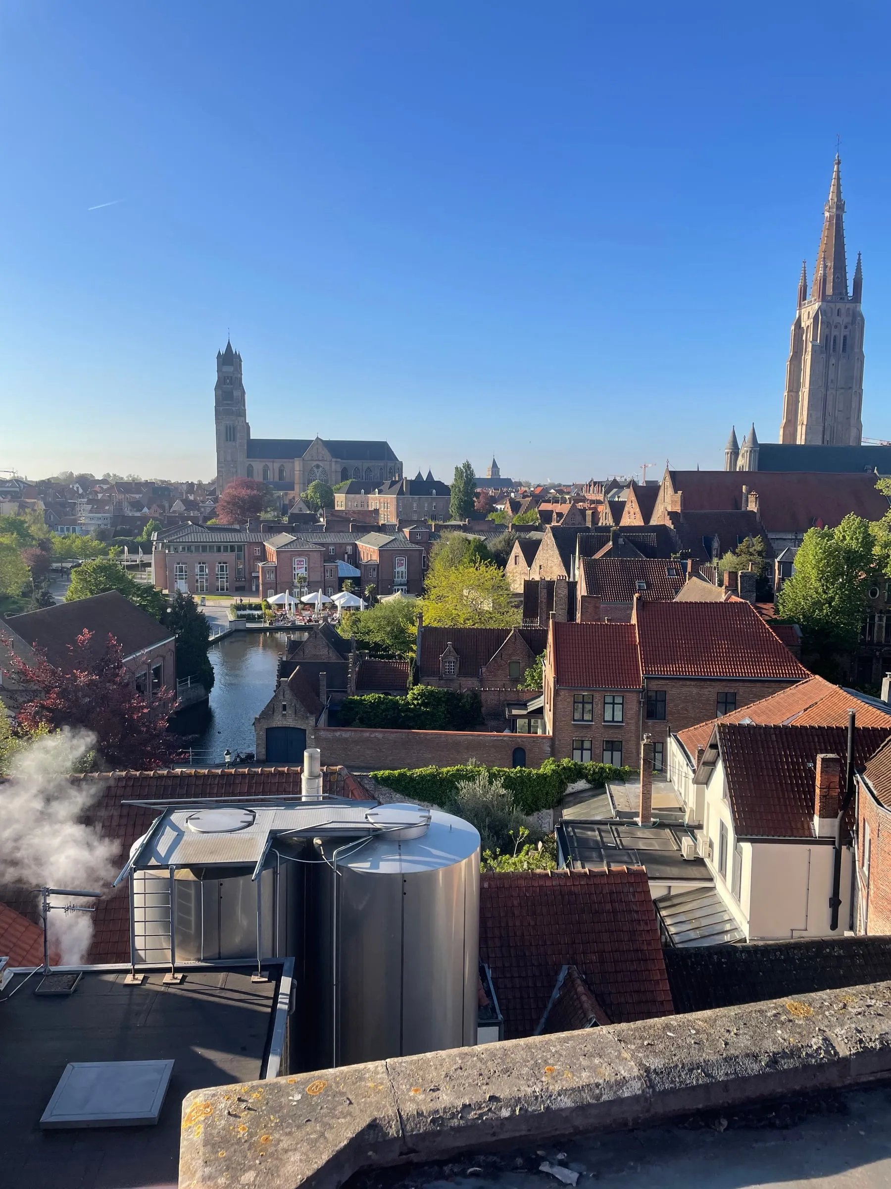 View over the rooftops and church towers of Bruges on a sunny day