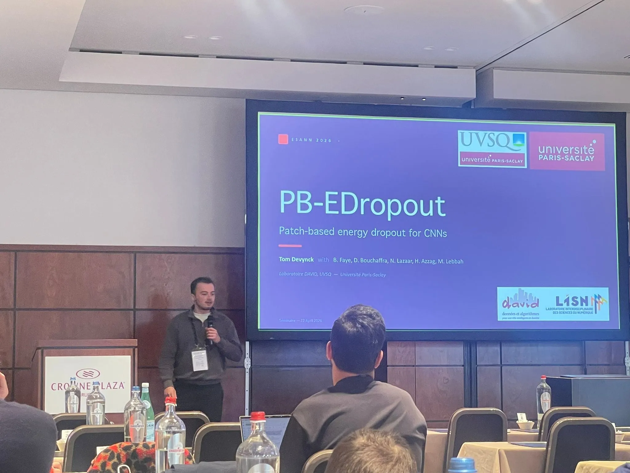Tom Devynck presenting PB-EDropout, patch-based energy dropout for CNNs, in a conference room at ESANN 2026